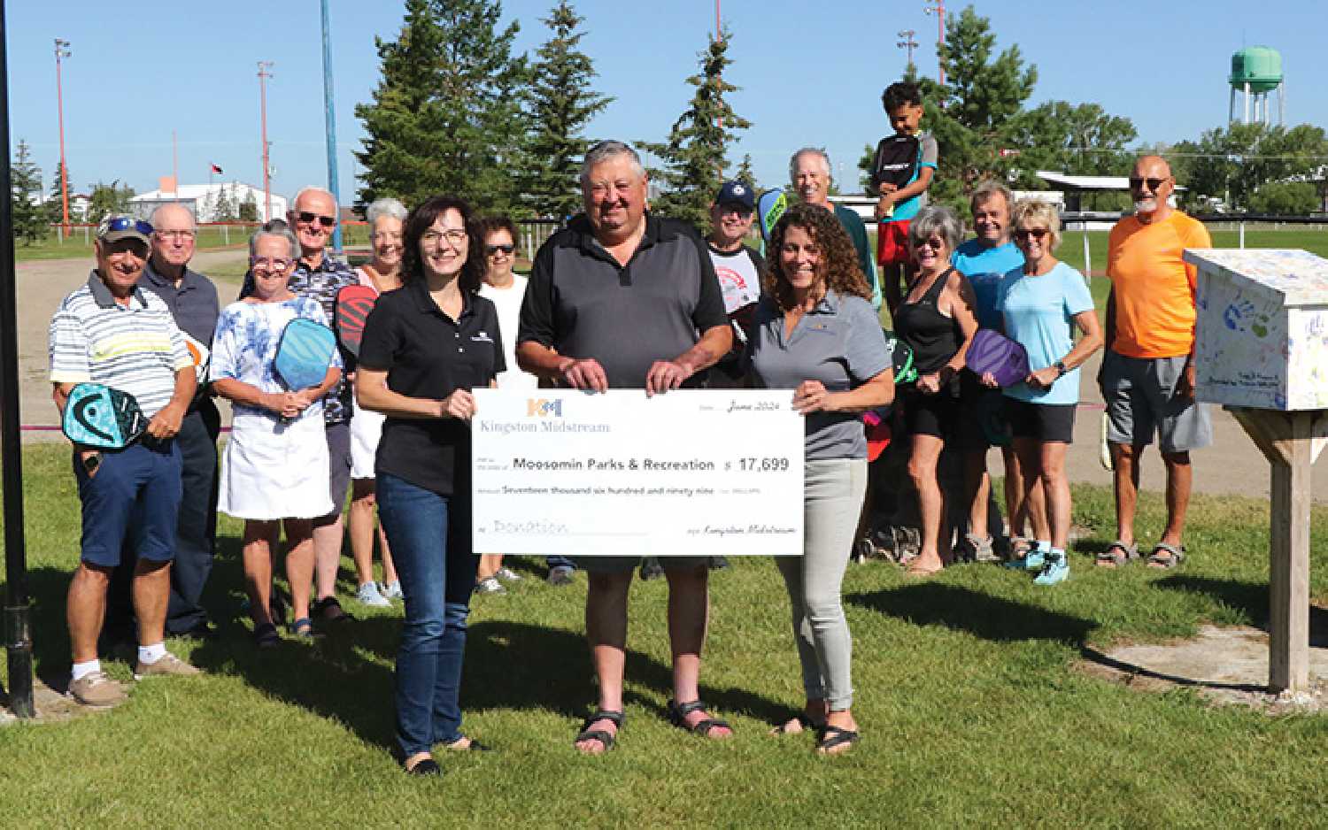 Moosomin Mayor Larry Tomlinson accepting the donation for new pickleball courts from Kingston Midstreams Dena Bachorcik, left, and Tammy Davies, right.